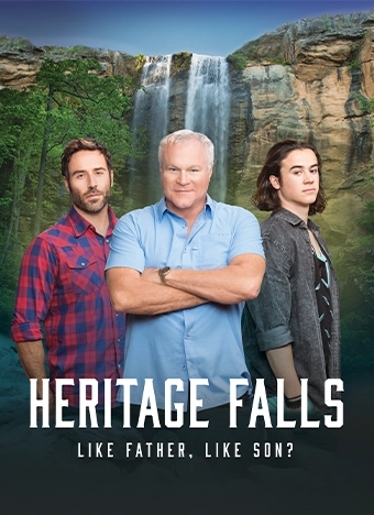 Heritage Falls movie poster featuring three generations of a family standing on a mountain with a picturesque background. The title 'Heritage Falls' is prominently displayed at the top with the tagline 'Like Father. Like Son?' at the bottom.