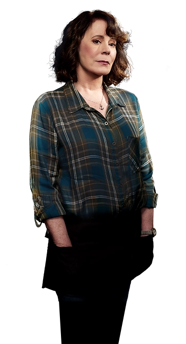 Patricia Richardson as Maddie Hall in the County Line movies. She is standing sideways with a soft look on her face, and her hands in her pockets.