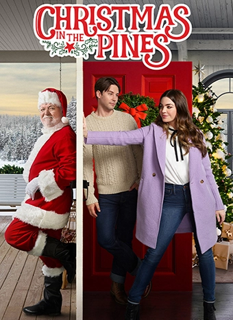 Movie poster for Christmas in the Pines. A smiling man dressed as Santa stands on the left side of an open red door, while a young couple stands on the right side in front of a decorated Christmas tree. The woman, wearing a purple coat and jeans, is pushing the man playfully as they look at each other. Snow-covered trees and holiday decorations can be seen in the background.